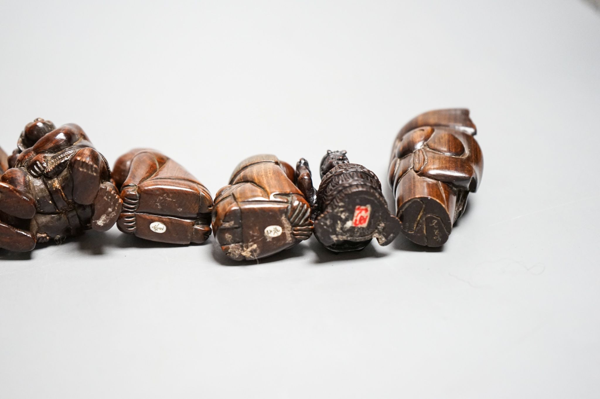 A quantity of hardwood netsuke and other carvings, signed